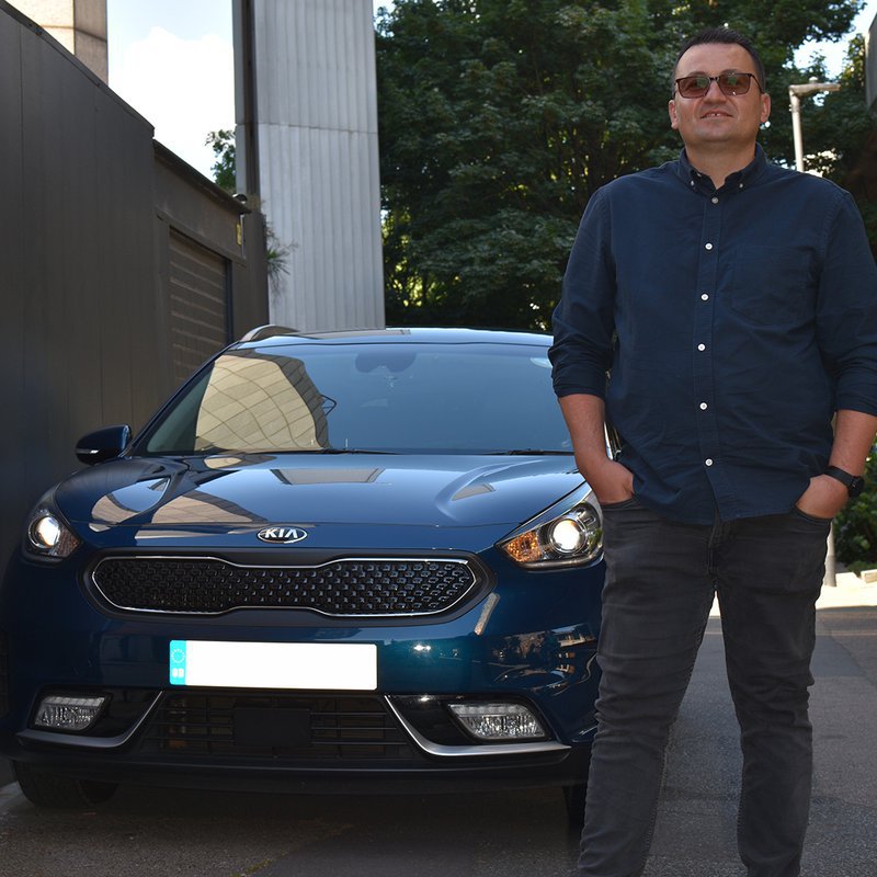 An Uber driver pictured with his Kia Niro