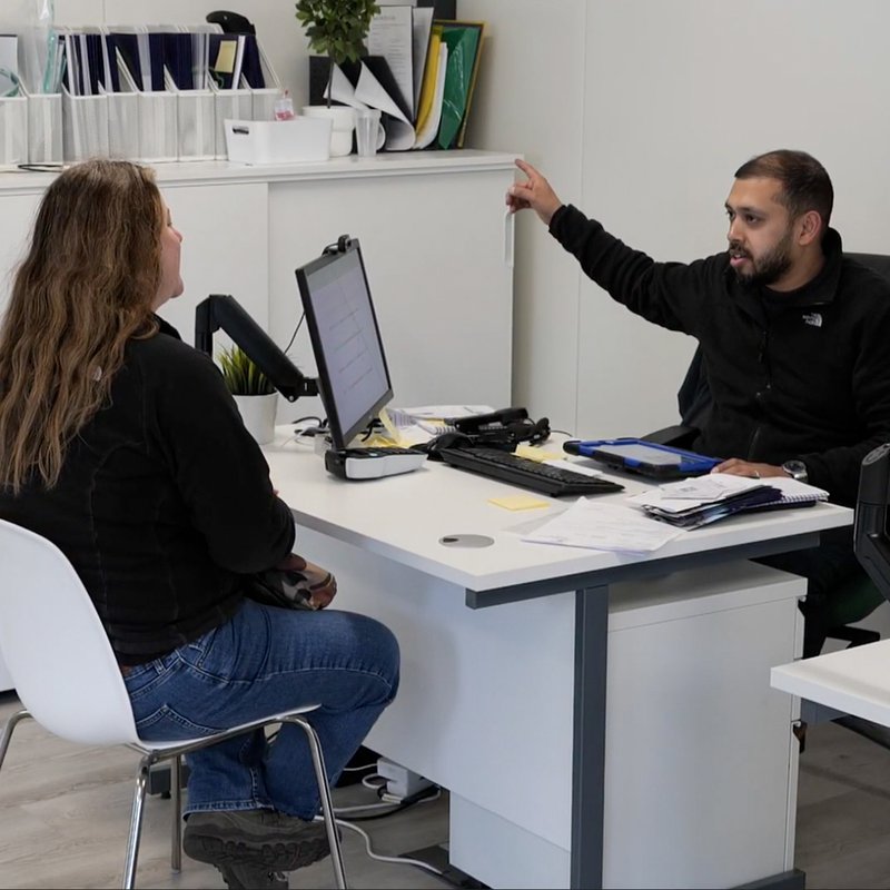 Private hire driver speaking with an Otto Car employee in the hub
