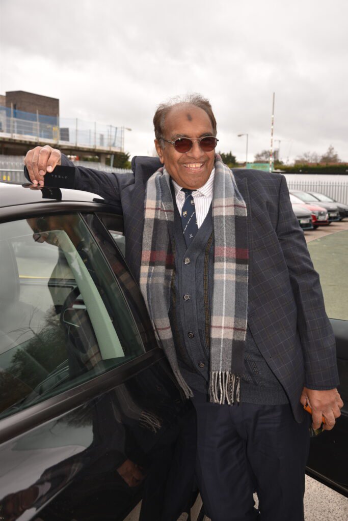 PCO%20driver%20Isaac%20smiling%20next%20to%20his%20new%20Tesla%20Model%203%20with%20Otto%20Car