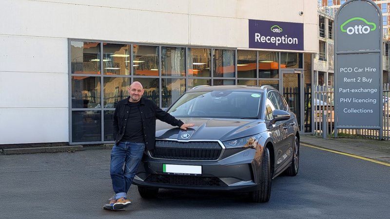 Man%20leaning%20on%20his%20Skoda%20Enyaq%20outside%20on%20the%20Otto%20Car%20Hendon%20hub%20reception