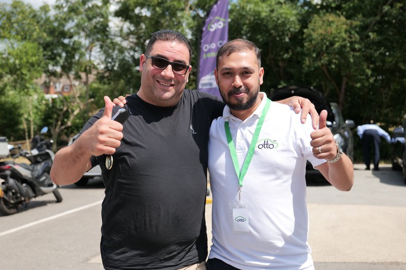 Otto%20Car%20staff%20member%20smiling%20with%20a%20PCO%20driver